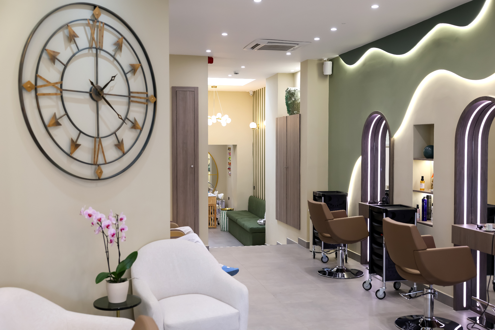 The Marnis Salon interior , sage-green walls, arched mirrors and soft natural light
